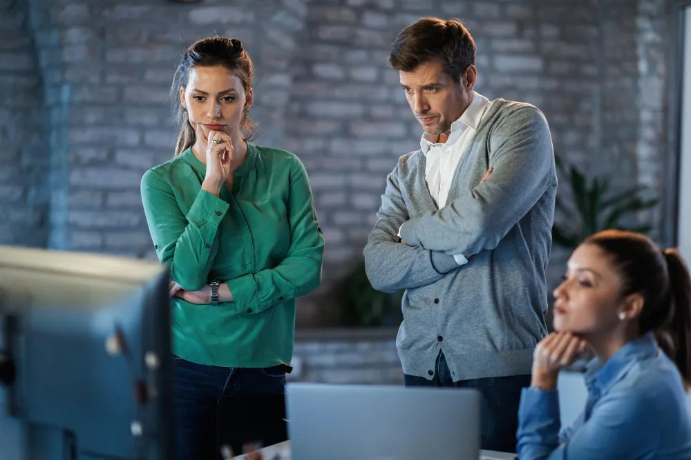 A business team in a planning session, working through the three silent killers of AI projects: pressure, FOMO, and anxiety